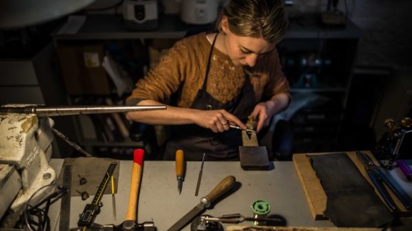 Woman making jewellery at her desk